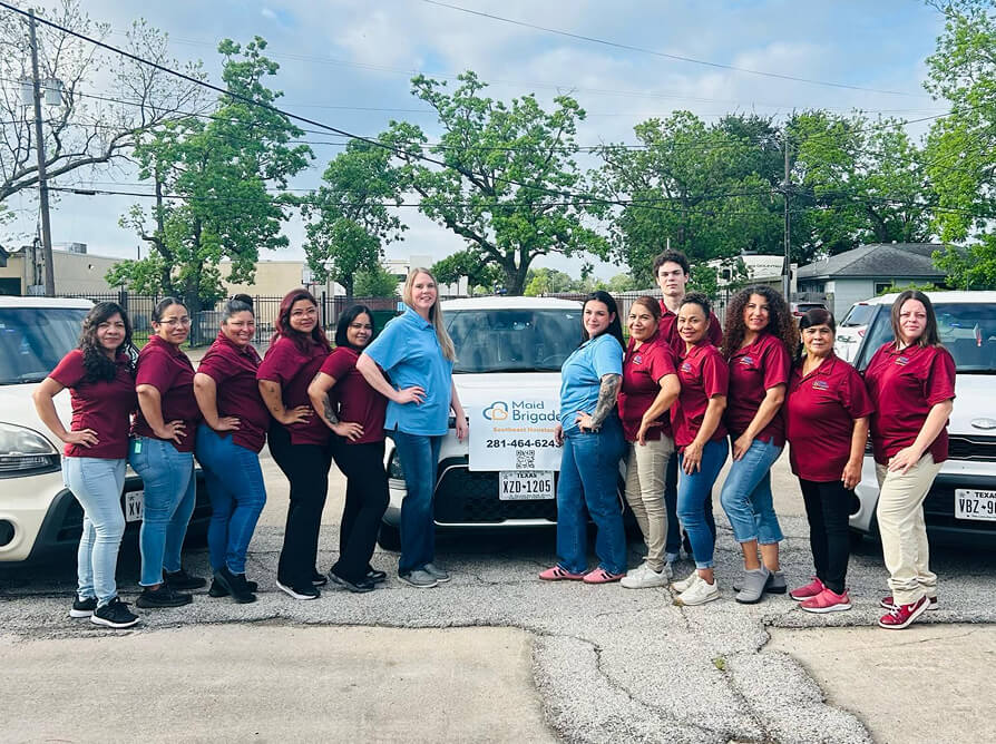 Team of happy cleaning techs smiling together
